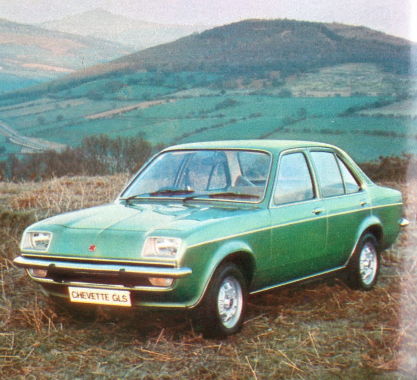 A green Vauxhall Chevette GLS Saloon (1976) photographed against rolling Welsh hills, period brochure shot