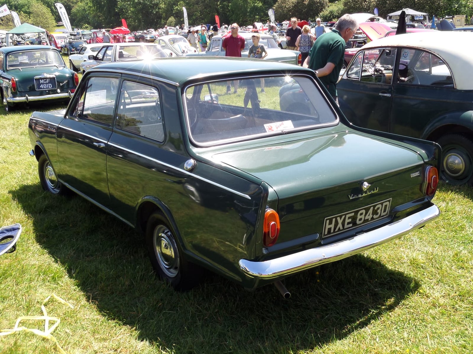 The rear three-quarter of a dark green 1966 Vauxhall Viva at a classic car show