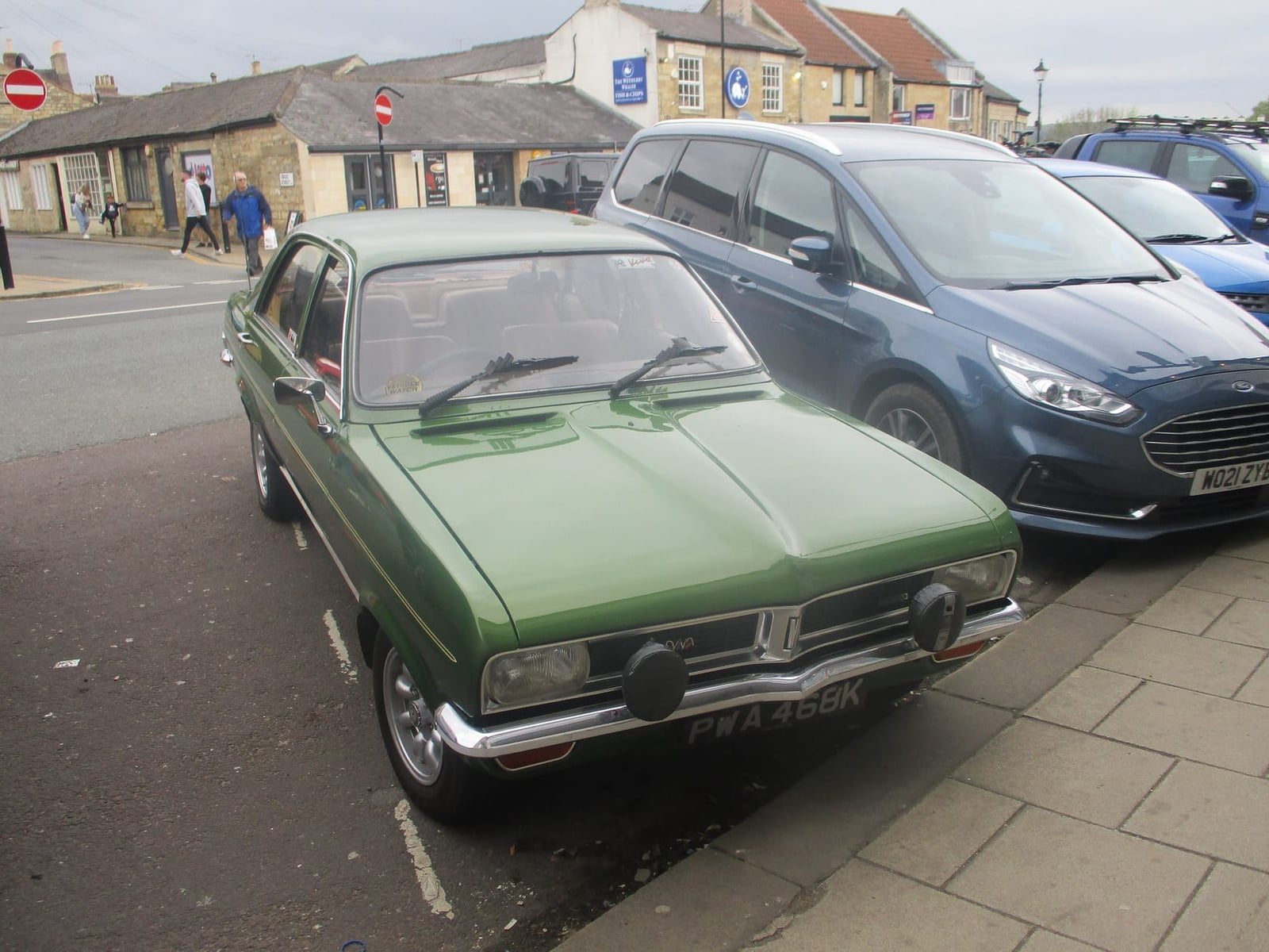 A green Vauxhall Viva HC parked among modern cars in a market place, front three-quarter view, UK registration PWA 468K