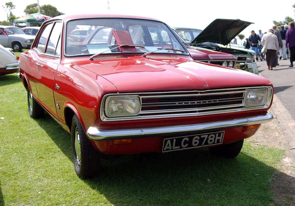A red Vauxhall Viva at a classic car show, front three-quarter view, UK registration ALC 678H