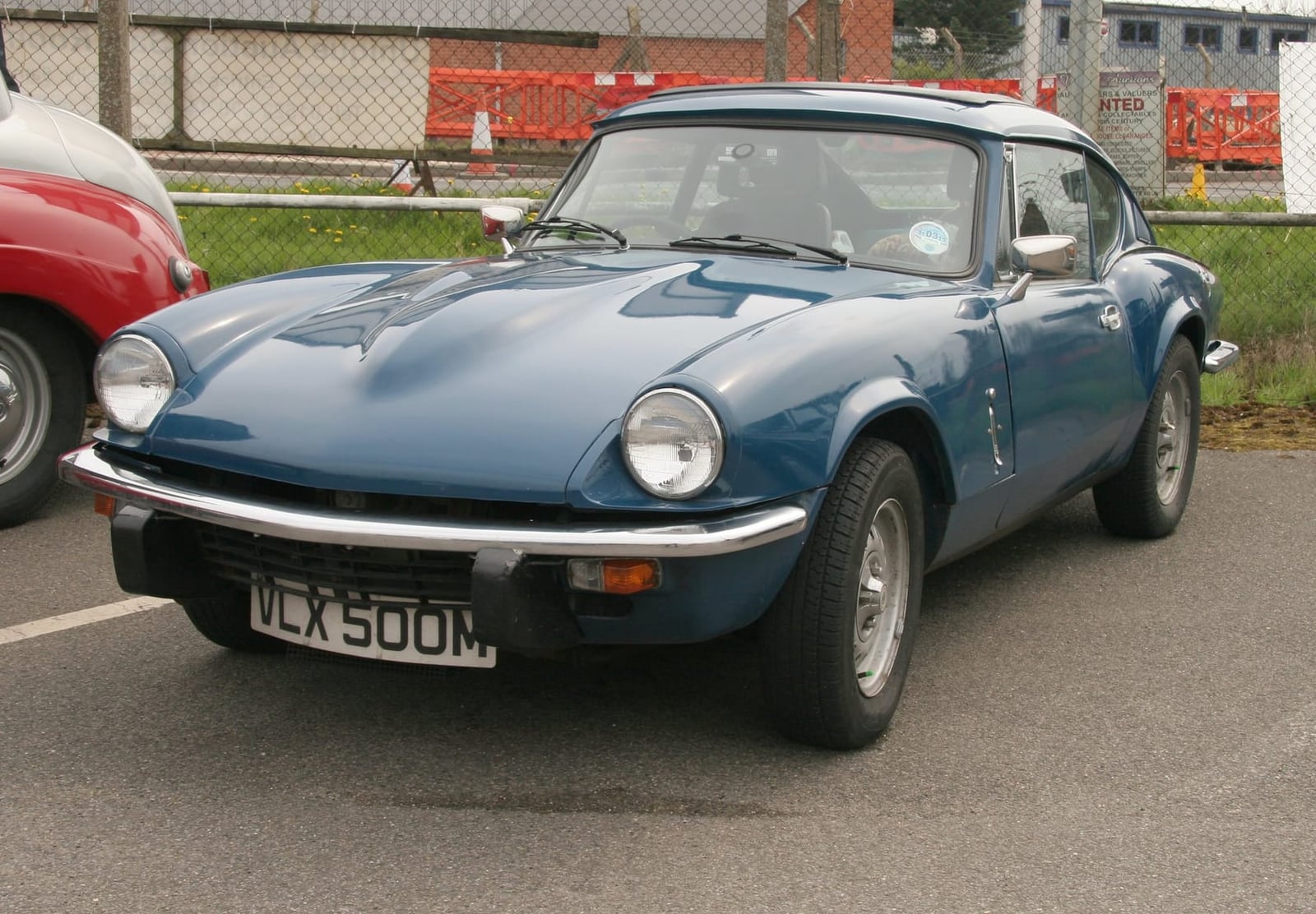 A blue Triumph GT6 Mk3 fastback coupe, front three-quarter view